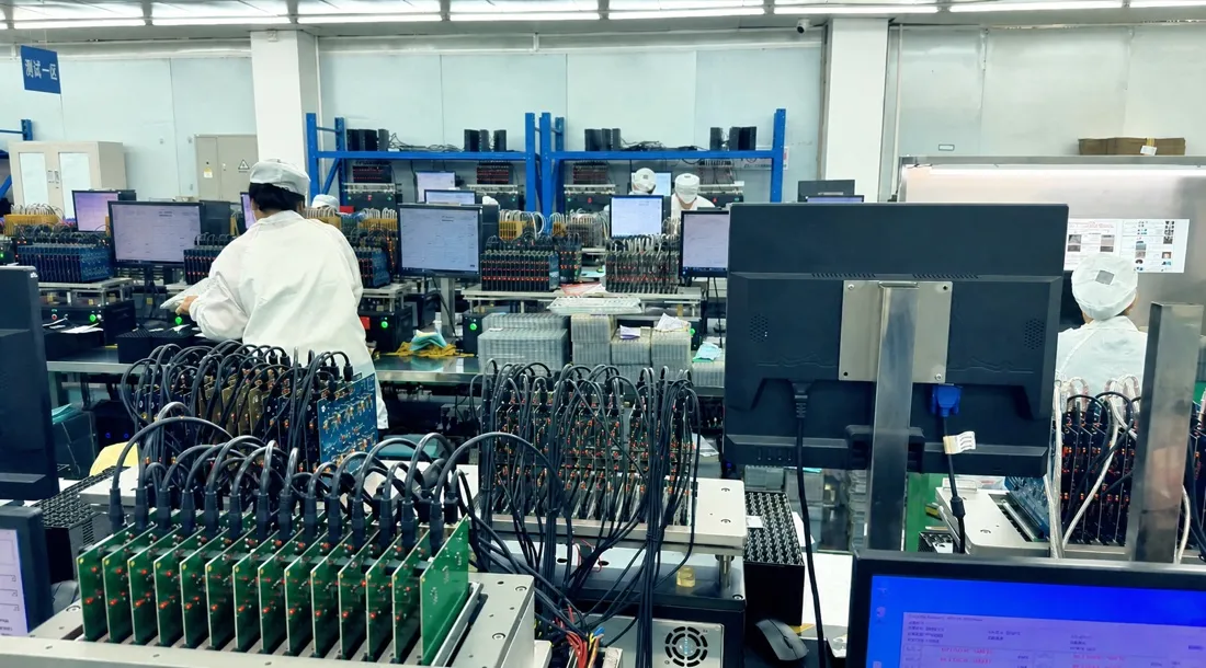 Wide view of flash-storage test stations at a manufacturing partner supporting Kalstor B2B projects